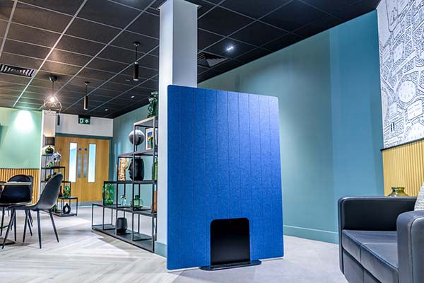 Modern office space with an acoustic grooved blue partition screen