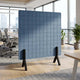 Blue square acoustic room divider in an office setting with wooden legs