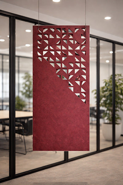 Red decorative panel with geometric cutouts from the Ocean Green acoustic range in an office setting