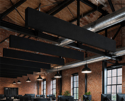 Modern office interior with exposed brick walls, large windows, and modern ceiling baffles