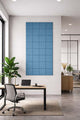 Modern office interior with a desk, chair, and square design wall panel.